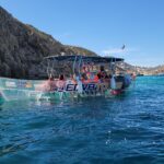 See-though boat in the turquoise waters of Cabo, Mexico