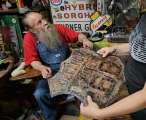Harley Russell showing off the oldest Route 66 Oklahoma sign